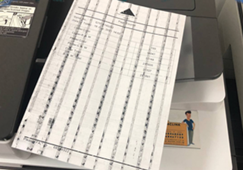 Paper with black lines indicates that the copier machine's roller drum needs fixing.